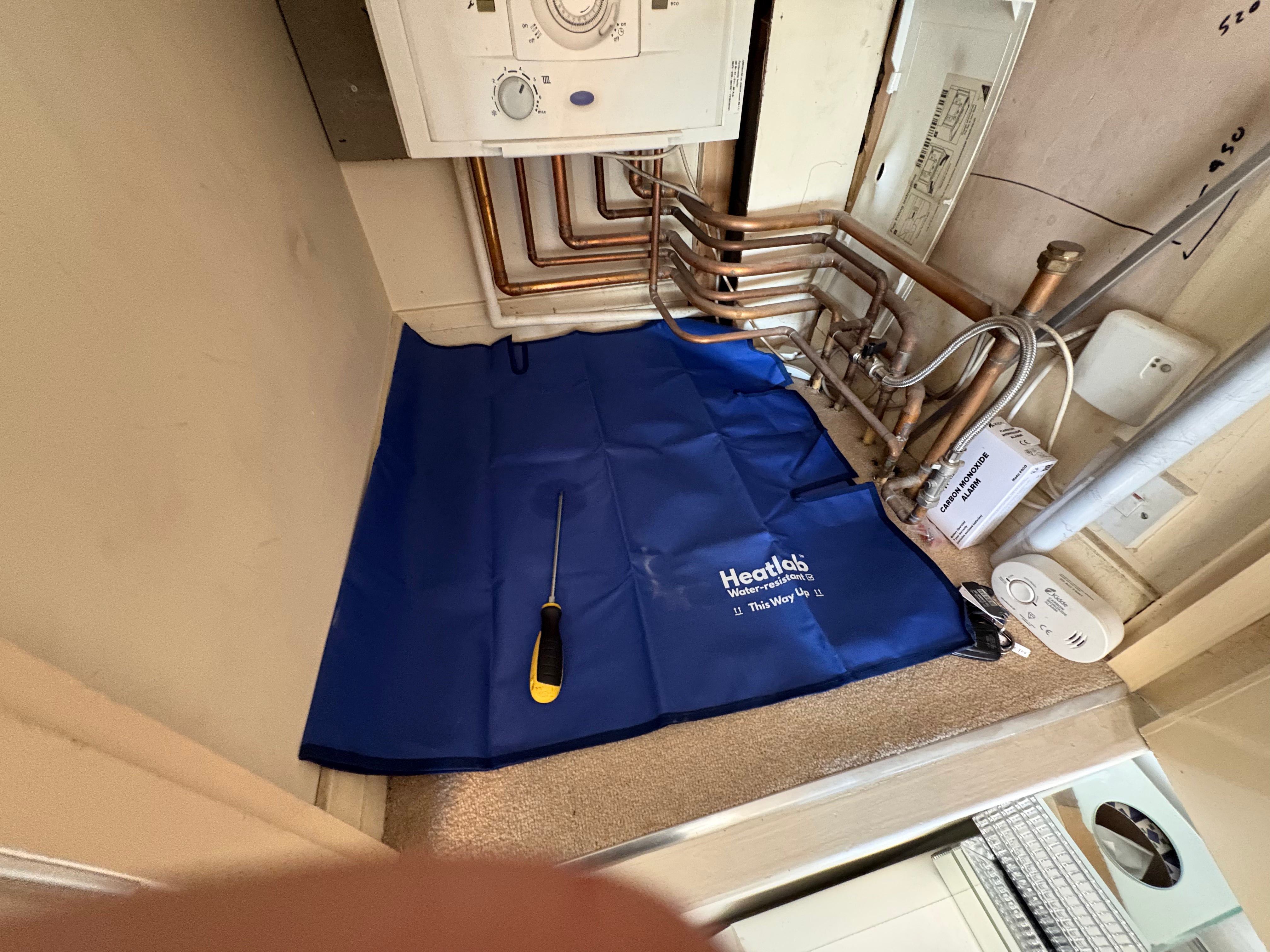 Plumbers Dust Sheet - The waterproof work mat that fits around radiator pipes.