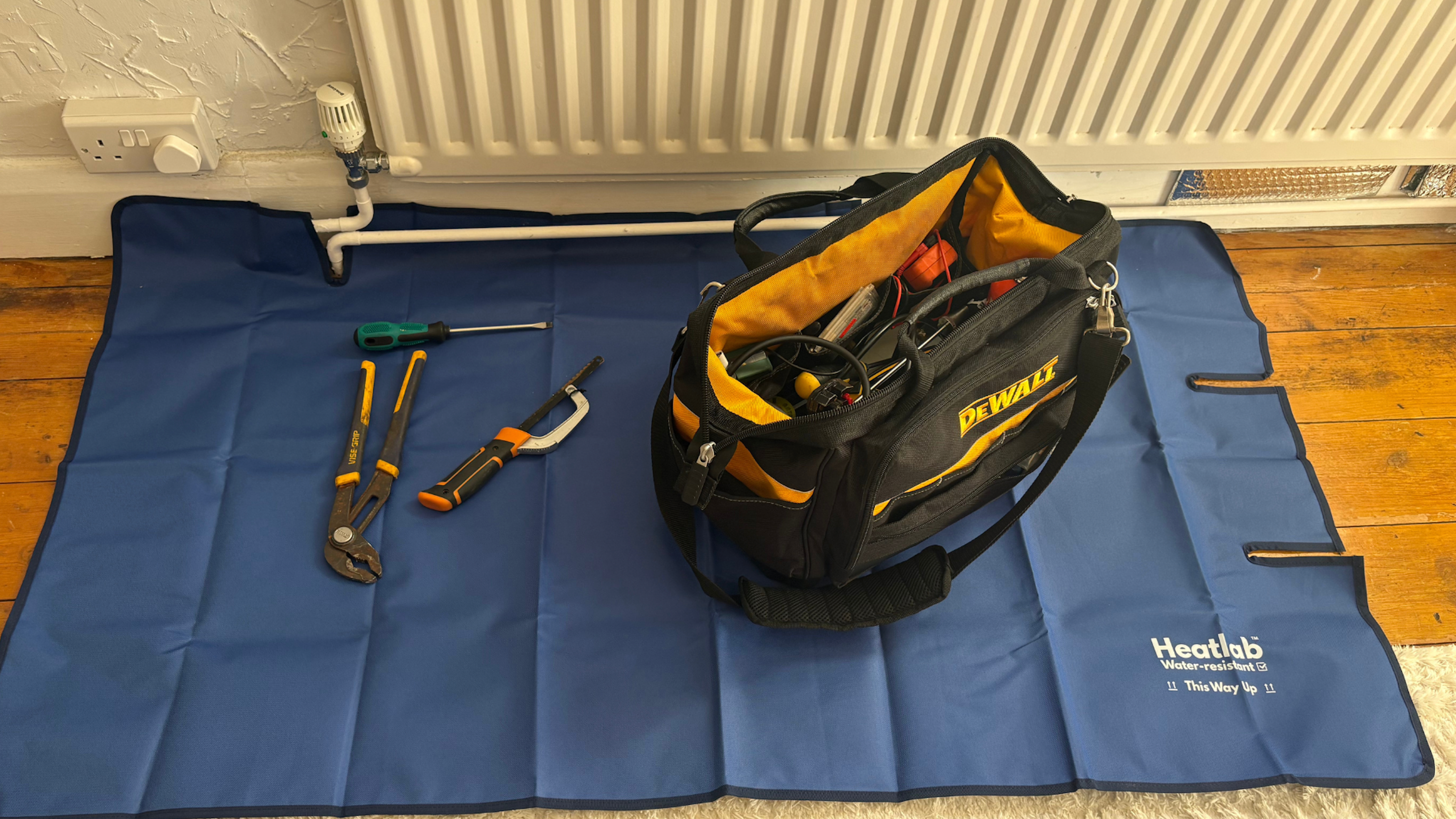 The waterproof work mat that fits around radiator pipes.